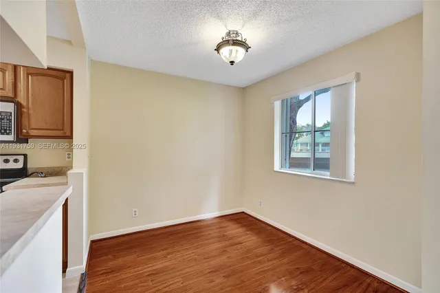 a kitchen with a refrigerator and a stove top oven