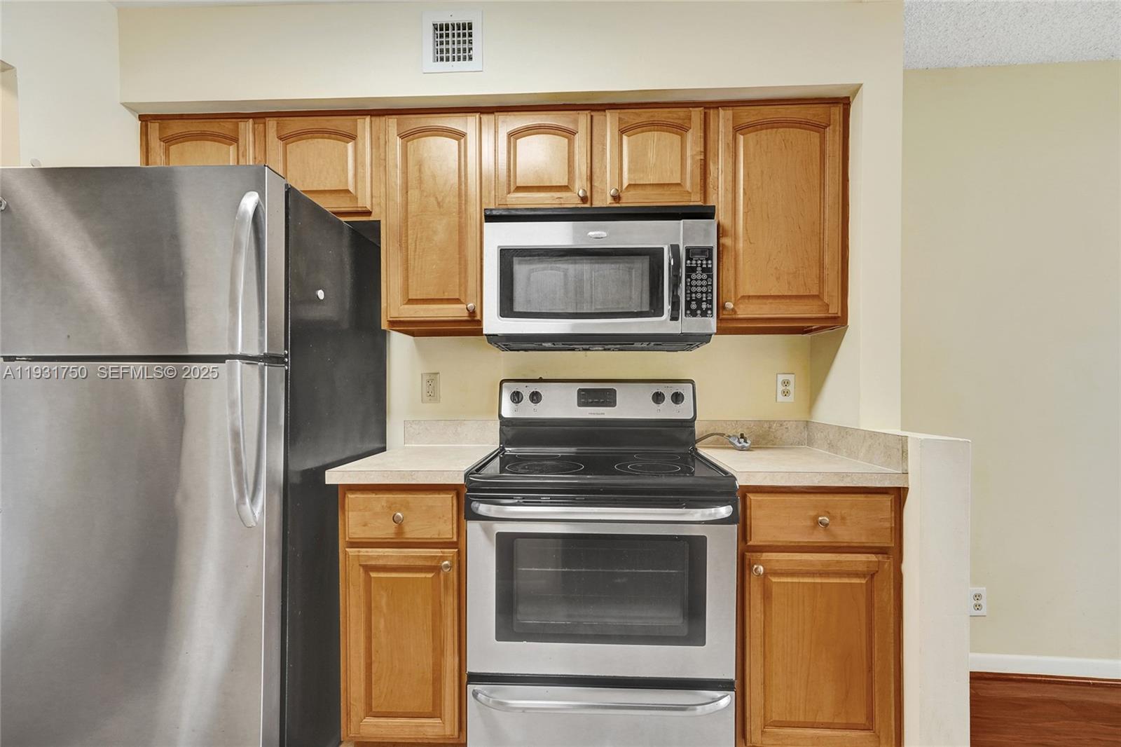 9833 Westview Drive, Unit 819 Coral Springs, FL 33076 - Photo 17 of 47 a kitchen with granite countertop cabinets stainless steel appliances and a counter space