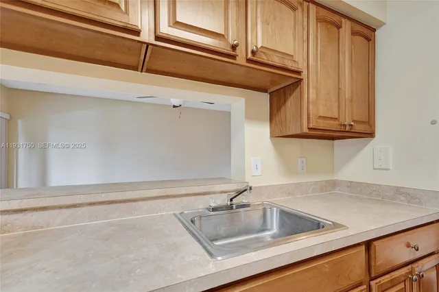 a kitchen with stainless steel appliances granite countertop a refrigerator and a stove