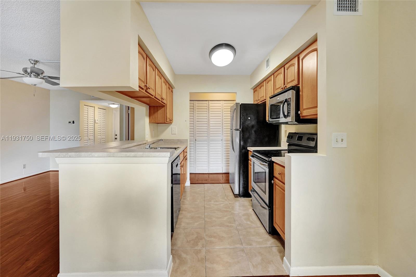 9833 Westview Drive, Unit 819 Coral Springs, FL 33076 - Photo 19 of 47 a kitchen with stainless steel appliances granite countertop a refrigerator and a stove