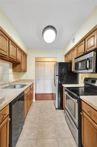 an empty room with wooden floor and fan