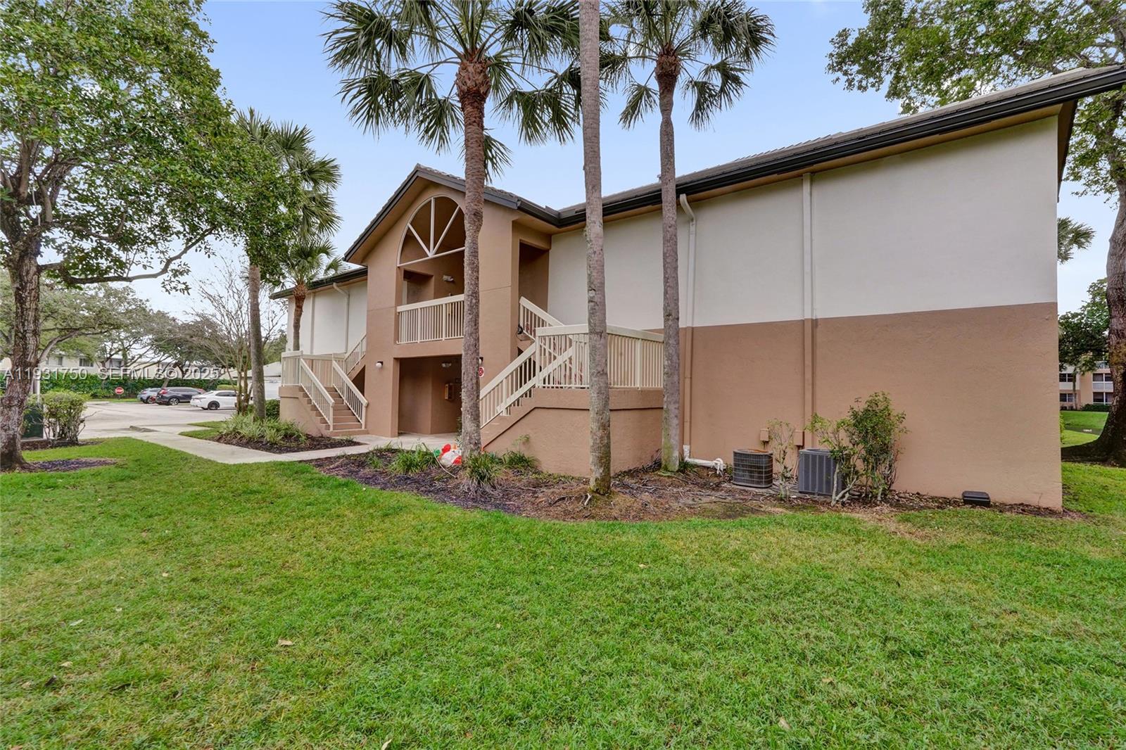 9833 Westview Drive, Unit 819 Coral Springs, FL 33076 - Photo 2 of 47 a house view with a garden space