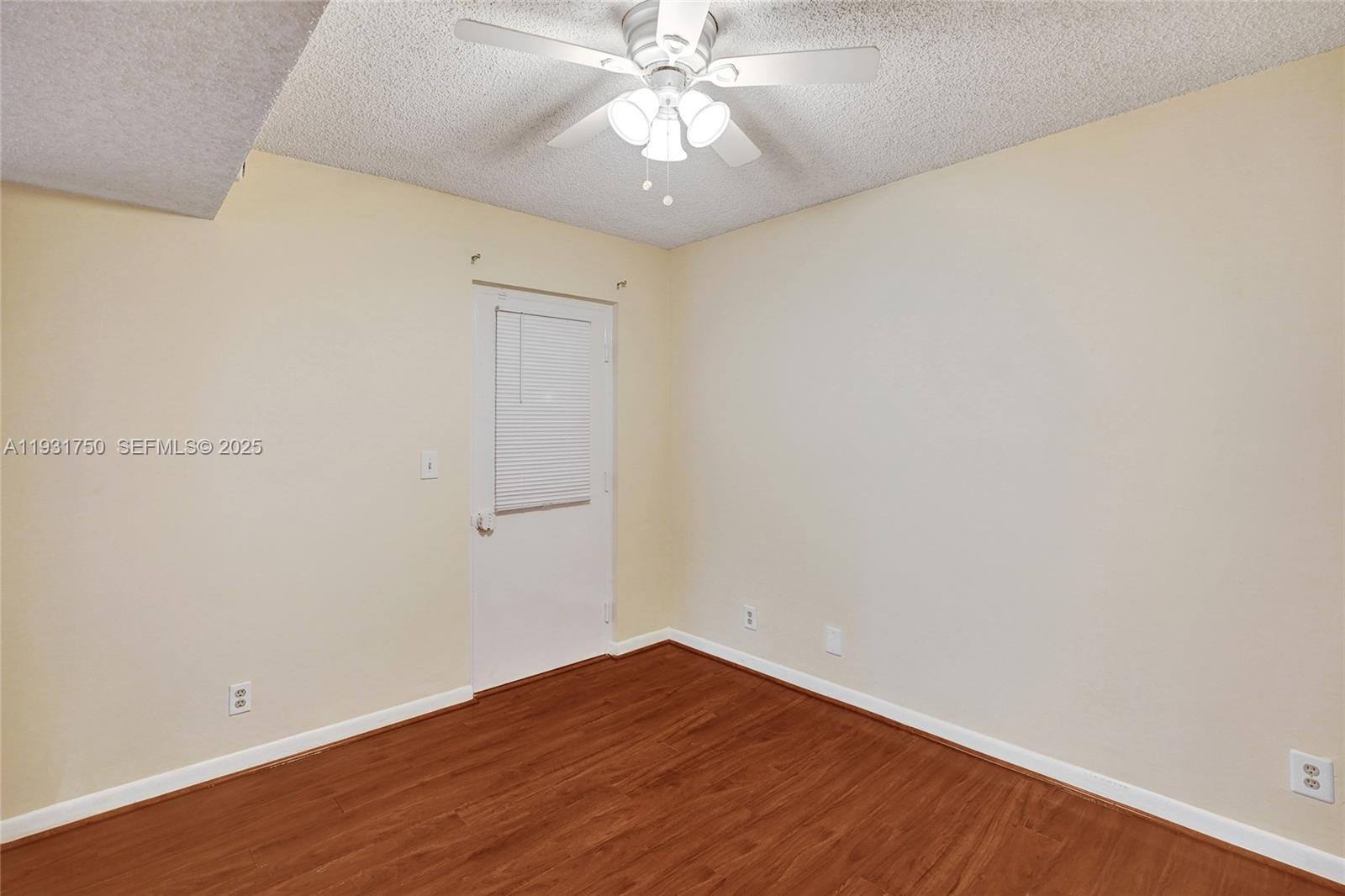 9833 Westview Drive, Unit 819 Coral Springs, FL 33076 - Photo 22 of 47 a view of an empty room with wooden floor and a ceiling fan