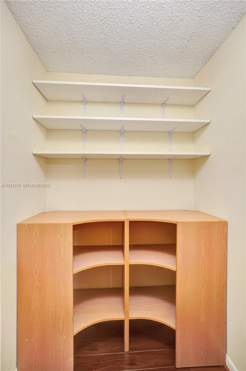 9833 Westview Drive, Unit 819 Coral Springs, FL 33076 - Photo 23 of 47 a view of walk in closet with empty racks