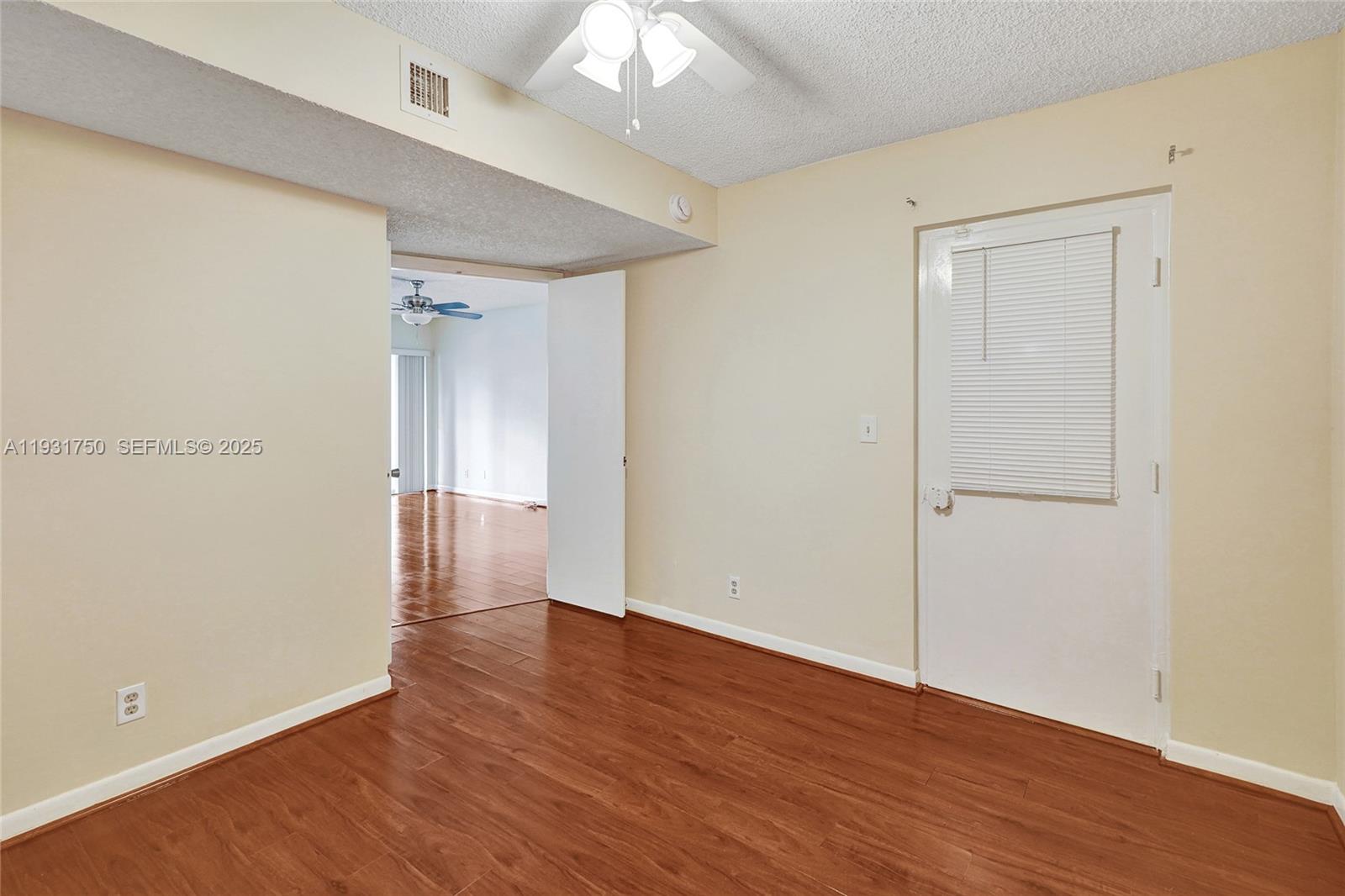 9833 Westview Drive, Unit 819 Coral Springs, FL 33076 - Photo 24 of 47 wooden floor in an empty room