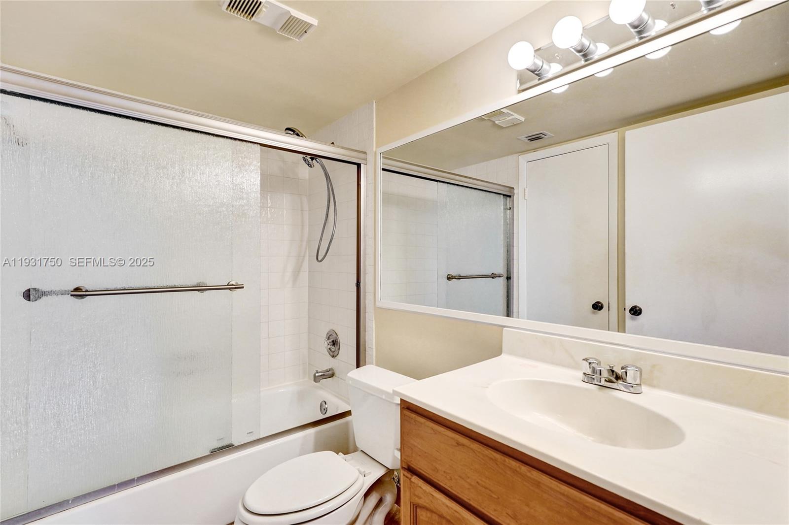 9833 Westview Drive, Unit 819 Coral Springs, FL 33076 - Photo 26 of 47 a bathroom with a sink toilet and shower