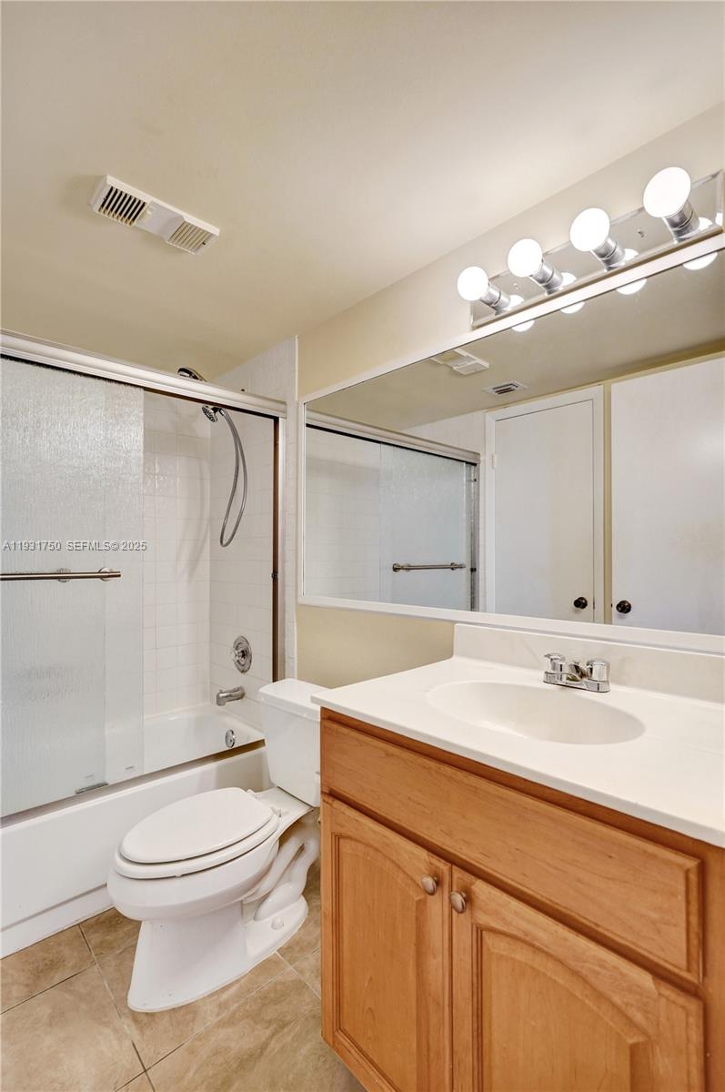 9833 Westview Drive, Unit 819 Coral Springs, FL 33076 - Photo 27 of 47 a bathroom with a sink a toilet and shower