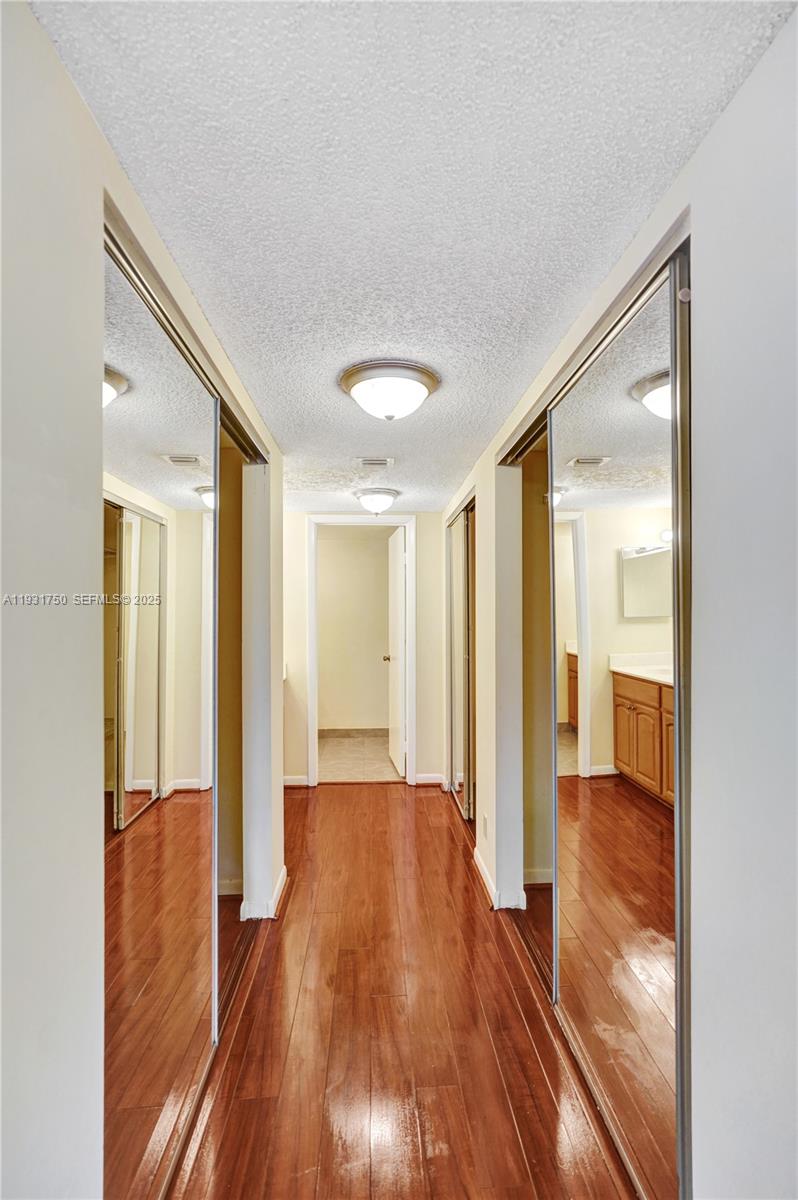 9833 Westview Drive, Unit 819 Coral Springs, FL 33076 - Photo 32 of 47 a view of a hallway with wooden floor and closet