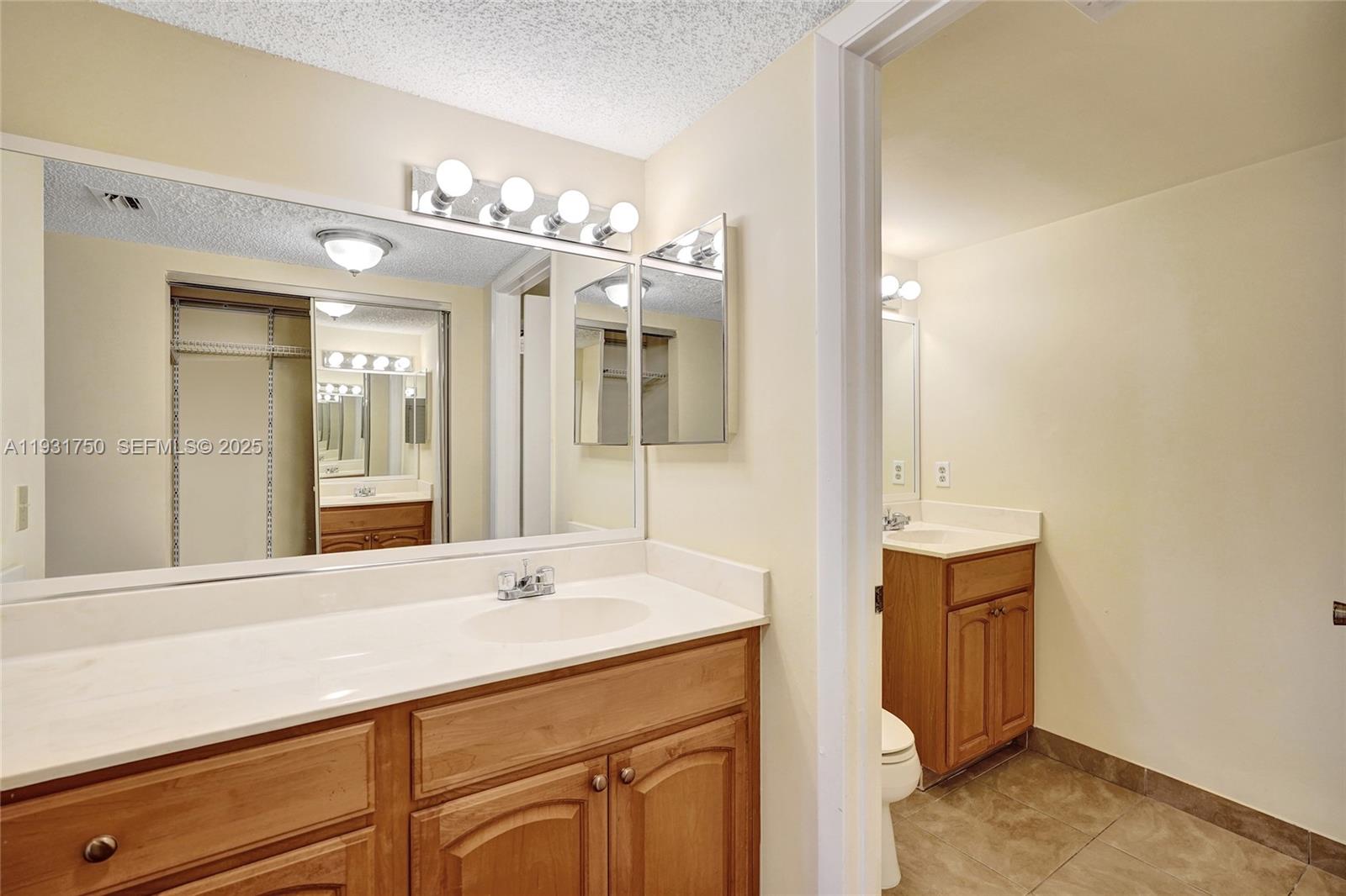 9833 Westview Drive, Unit 819 Coral Springs, FL 33076 - Photo 34 of 47 a bathroom with a sink and a mirror