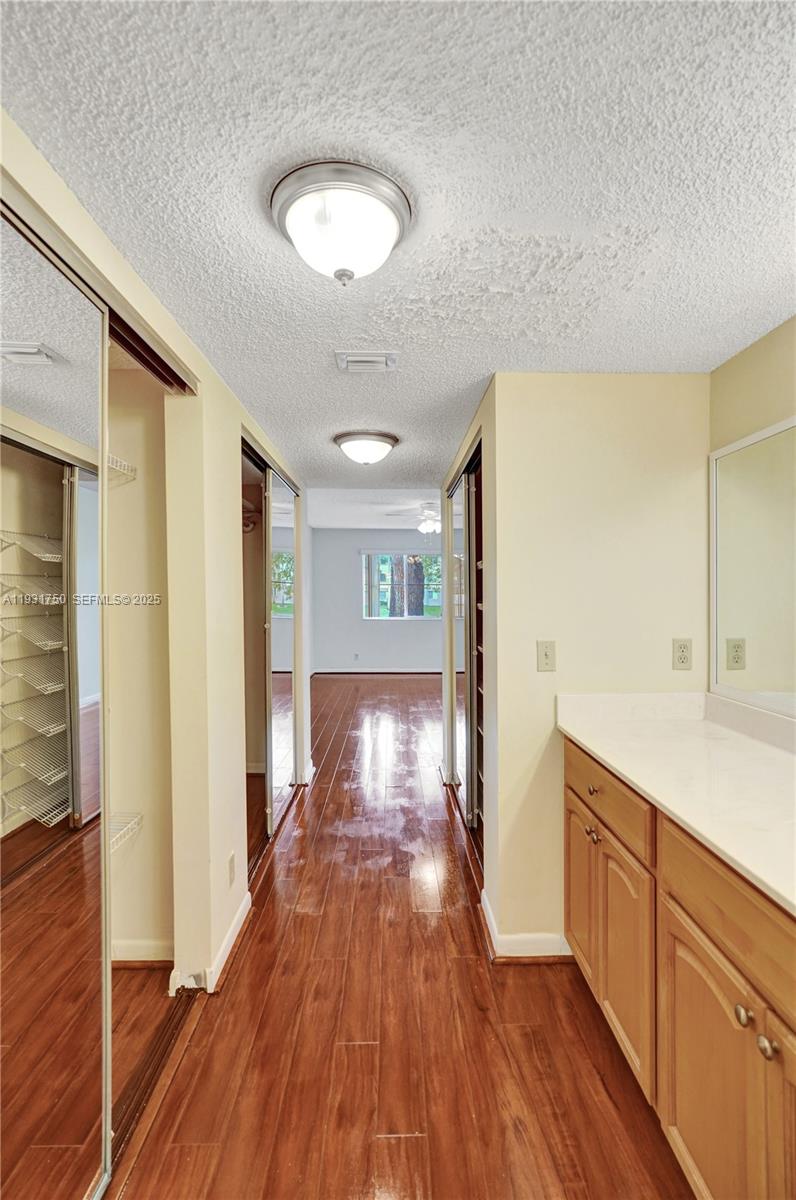 9833 Westview Drive, Unit 819 Coral Springs, FL 33076 - Photo 37 of 47 a view of hallway with wooden floor