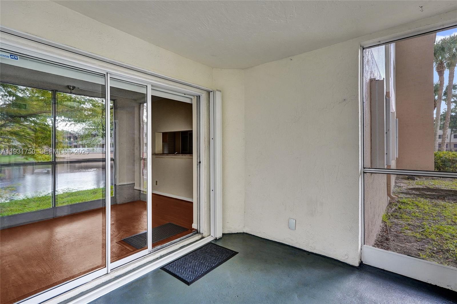 9833 Westview Drive, Unit 819 Coral Springs, FL 33076 - Photo 40 of 47 an empty room with sliding door