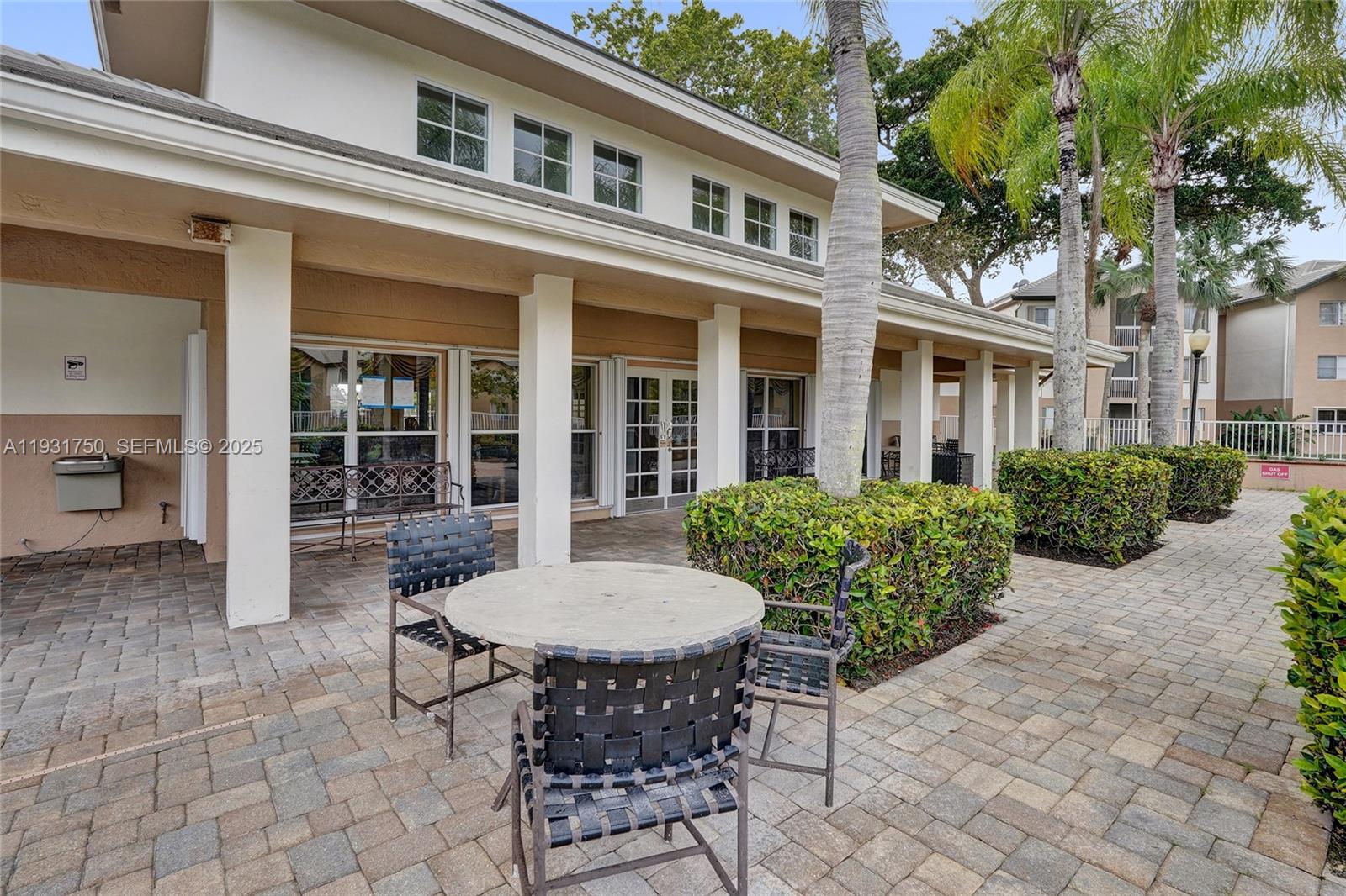 9833 Westview Drive, Unit 819 Coral Springs, FL 33076 - Photo 44 of 47 a view of a house with backyard sitting area and garden