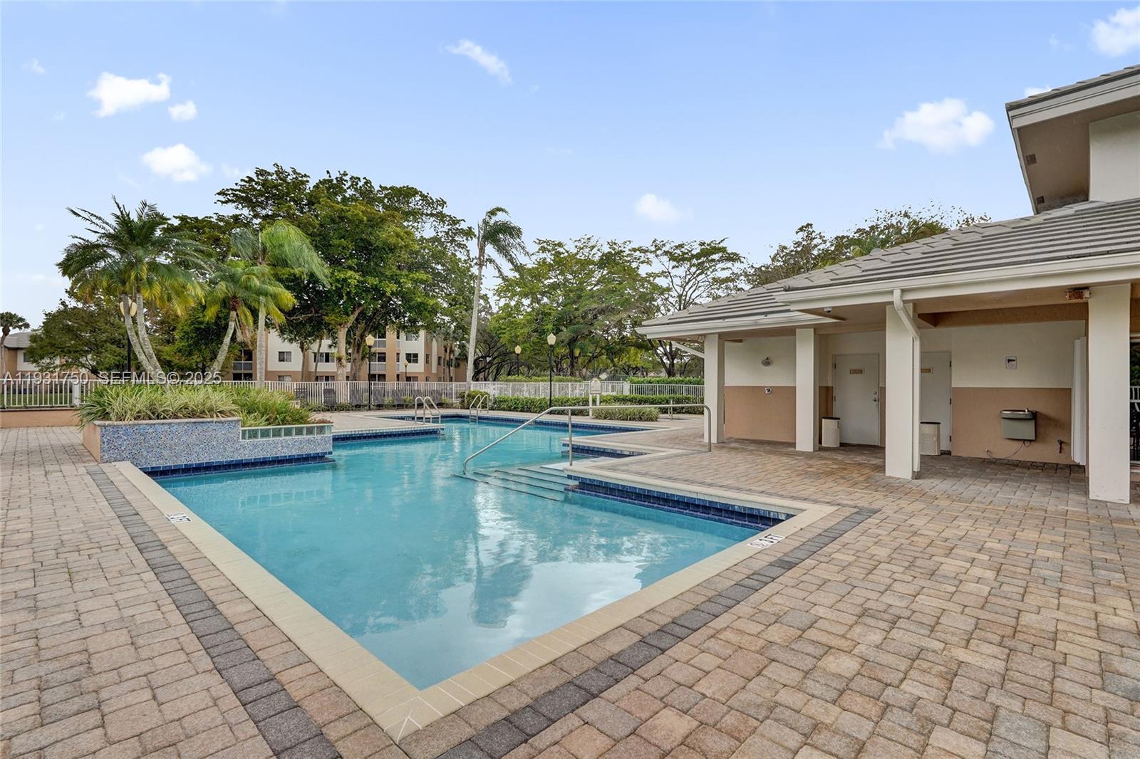 9833 Westview Drive, Unit 819 Coral Springs, FL 33076 - Photo 45 of 47 a view of a swimming pool with a lounge chairs