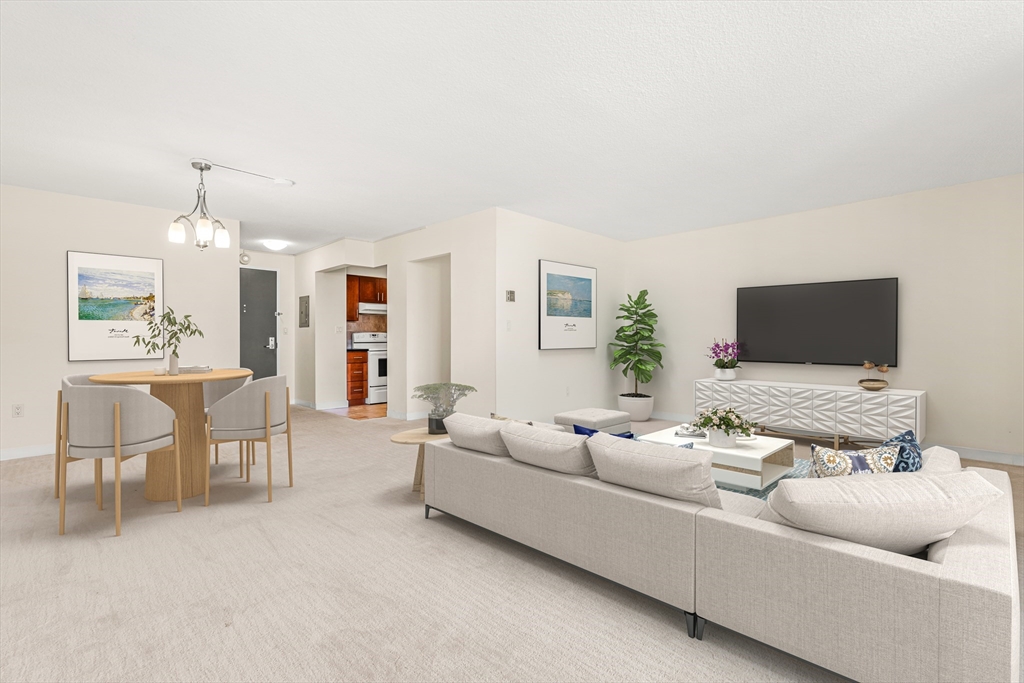 50 Longwood Avenue, Unit 611 Brookline, MA 02446 - Photo 2 of 8 a living room with furniture and a flat screen tv
