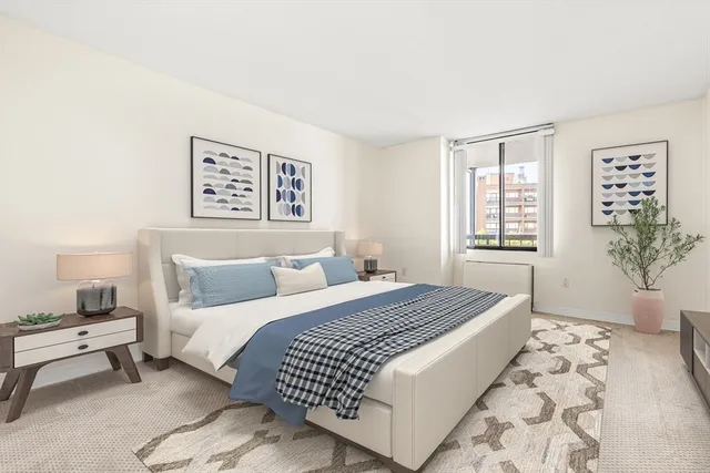 a bedroom with a large bed and a window