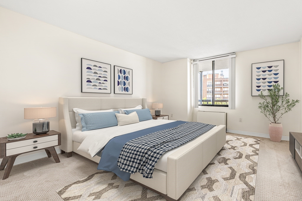 50 Longwood Avenue, Unit 611 Brookline, MA 02446 - Photo 3 of 8 a bedroom with a large bed and a window