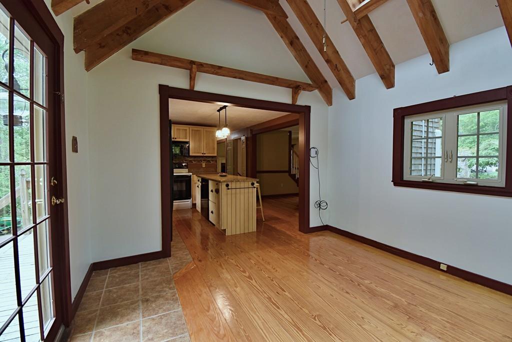 109 Purgatory Road Sutton, MA 01590 - Photo 16 of 33 a view of a hallway with wooden floor and a kitchen