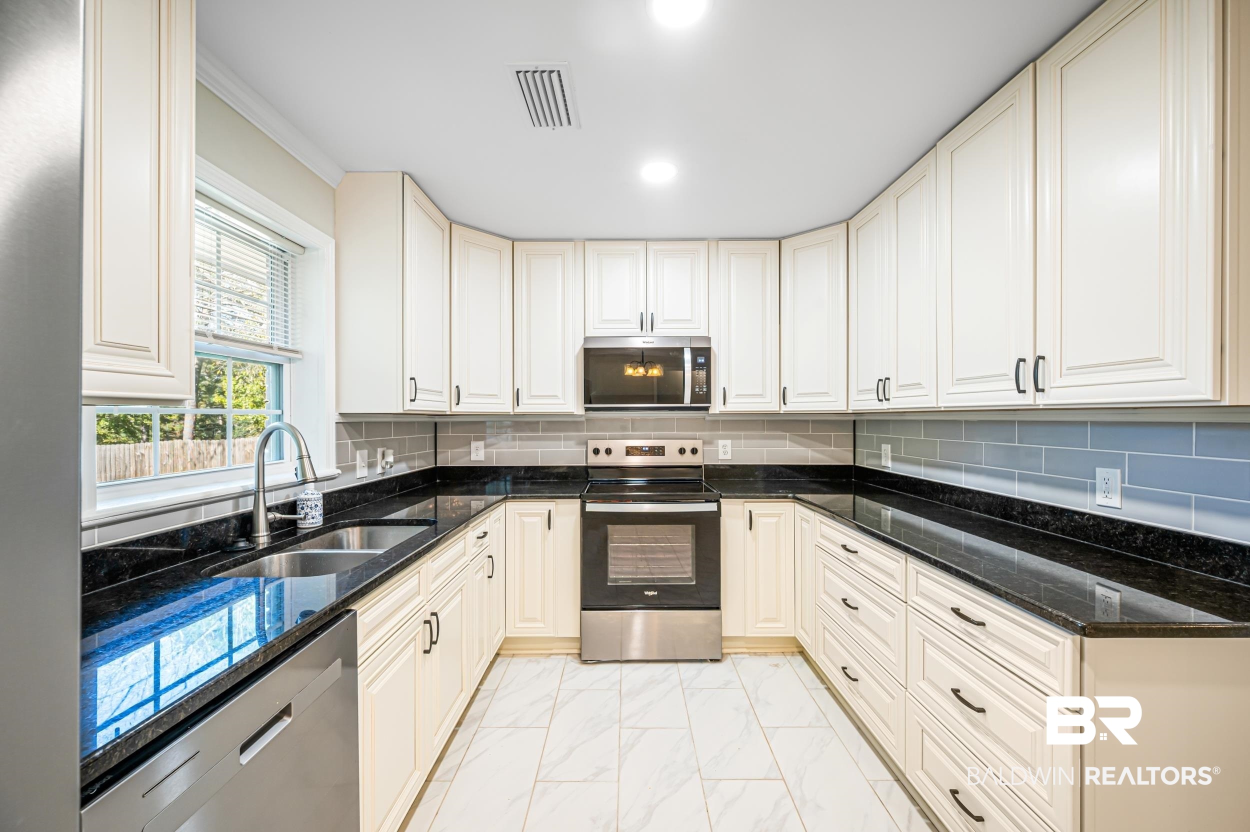 1605 Collier Avenue Bay Minette, AL 36507 - Photo 6 of 36 Kitchen with dark stone counters, stainless steel appliances, tasteful backsplash, light marble finish floors, and recessed lighting