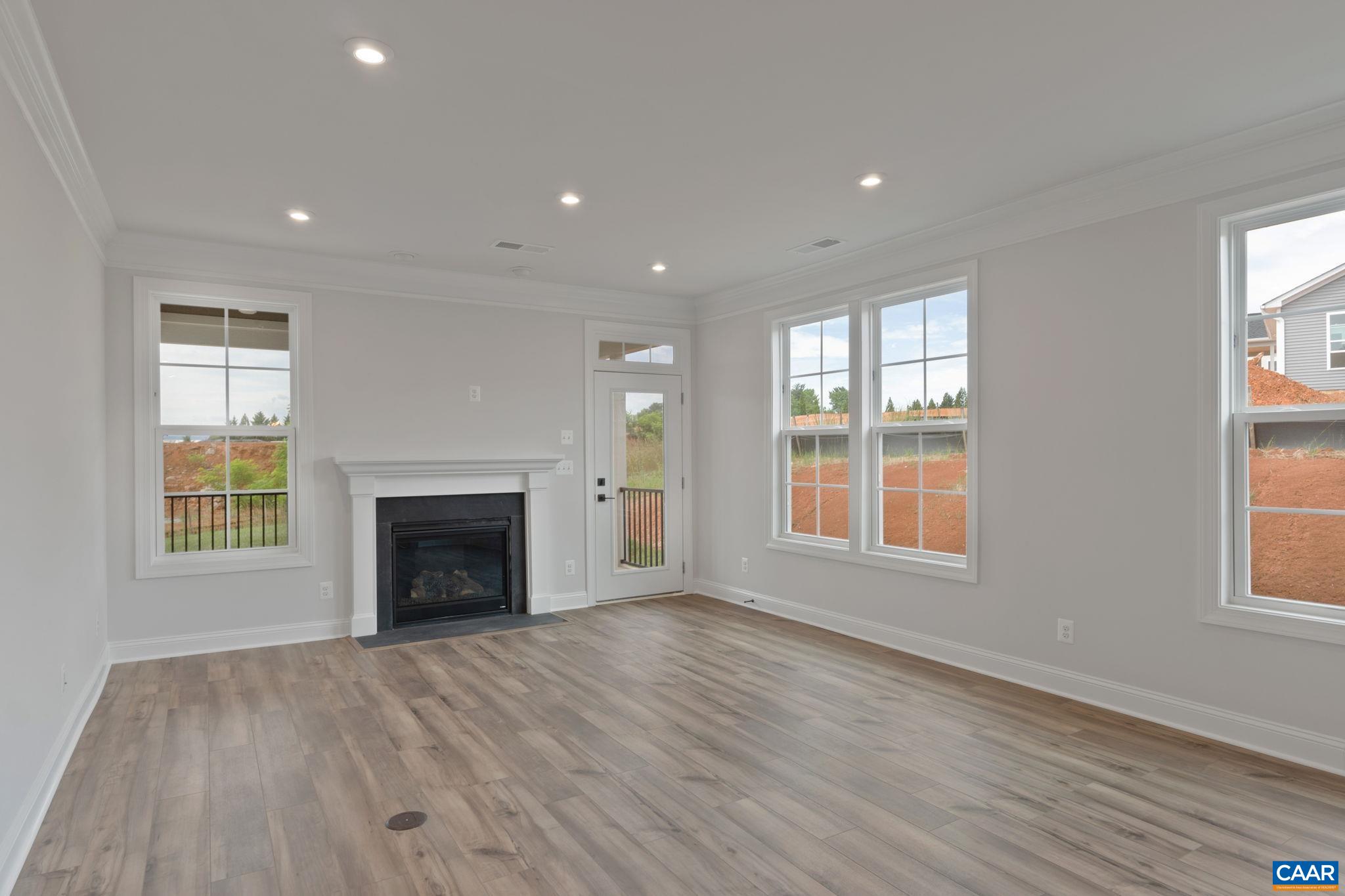 81 Springdale Road Waynesboro, VA 22980 - Photo 12 of 42 an empty room with wooden floor fireplace and windows