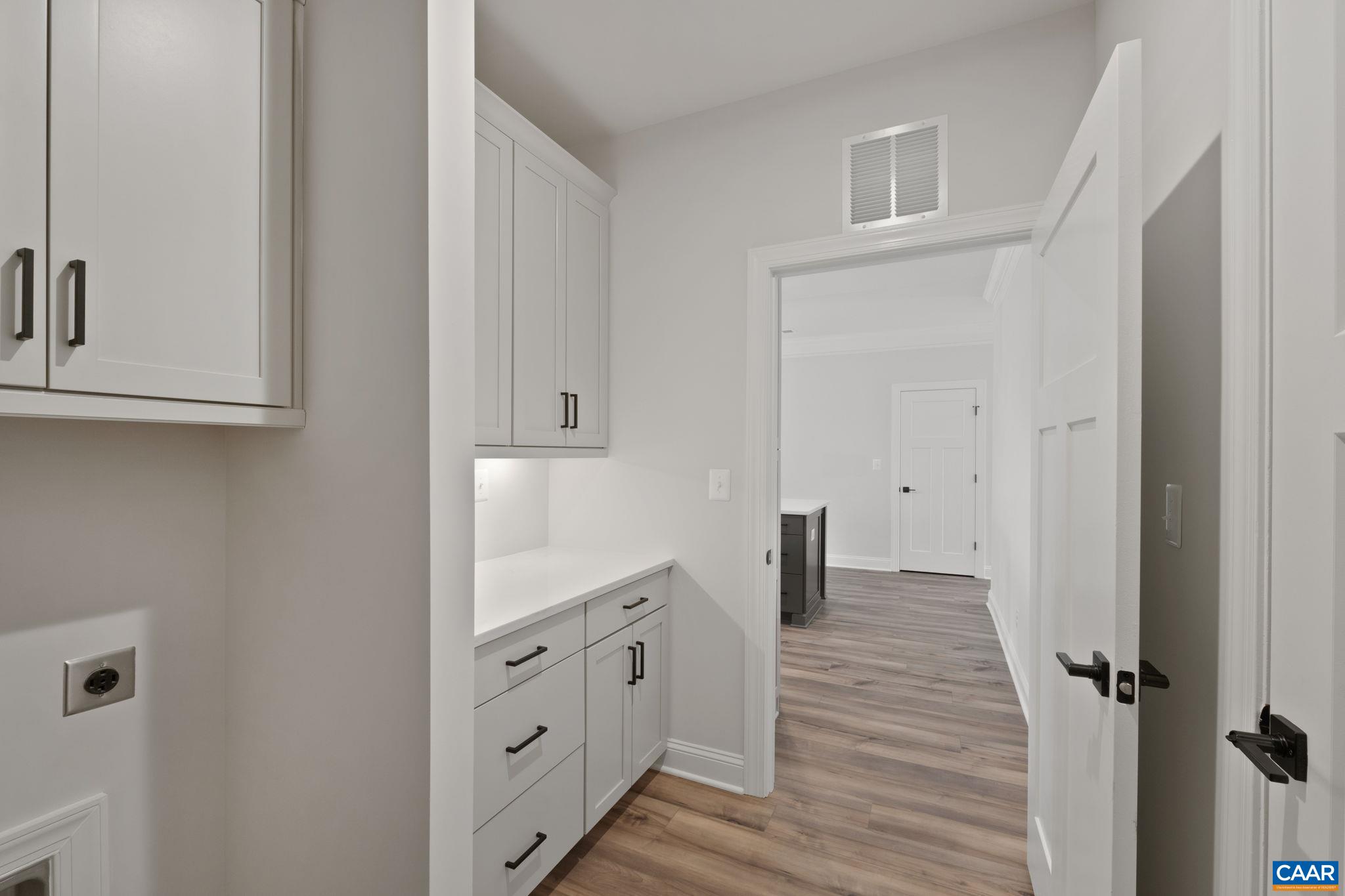 81 Springdale Road Waynesboro, VA 22980 - Photo 20 of 42 a hallway with white cabinets and wooden floor
