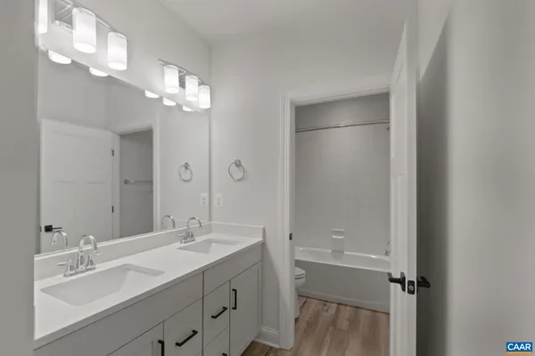a bathroom with a double vanity sink and a mirror
