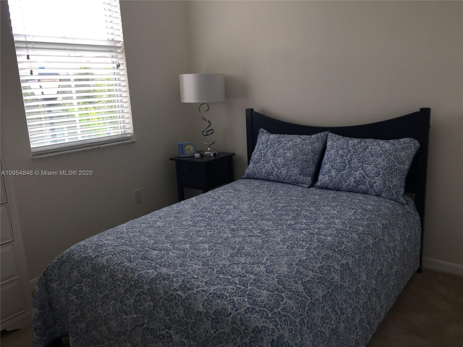 2851 Prospect Road, Unit 1306 Tamarac, FL 33309 - Photo 12 of 15 a bedroom with a bed and window