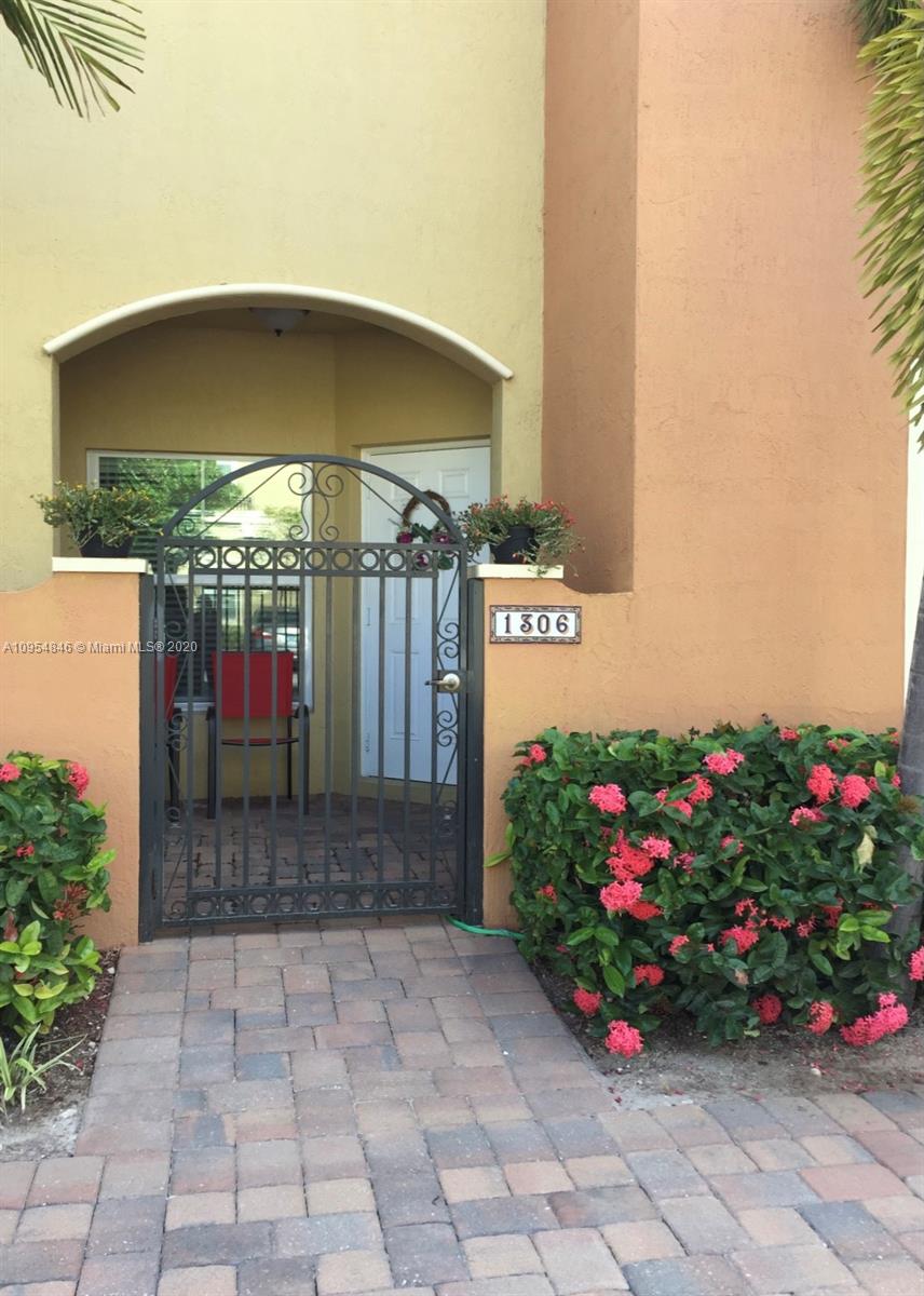 2851 Prospect Road, Unit 1306 Tamarac, FL 33309 - Photo 2 of 15 a front view of a house with flowers