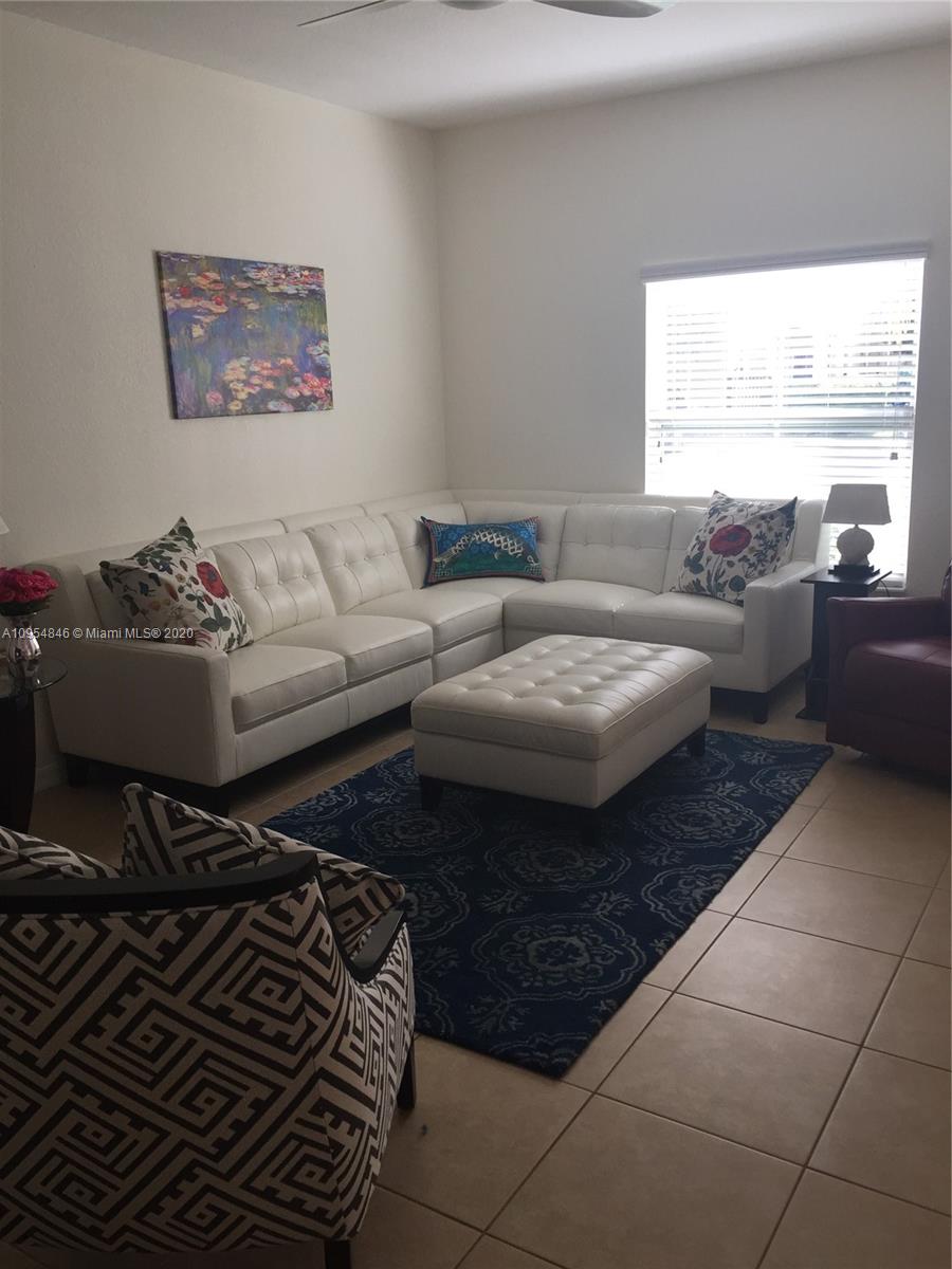 2851 Prospect Road, Unit 1306 Tamarac, FL 33309 - Photo 3 of 15 a living room with furniture and a large window