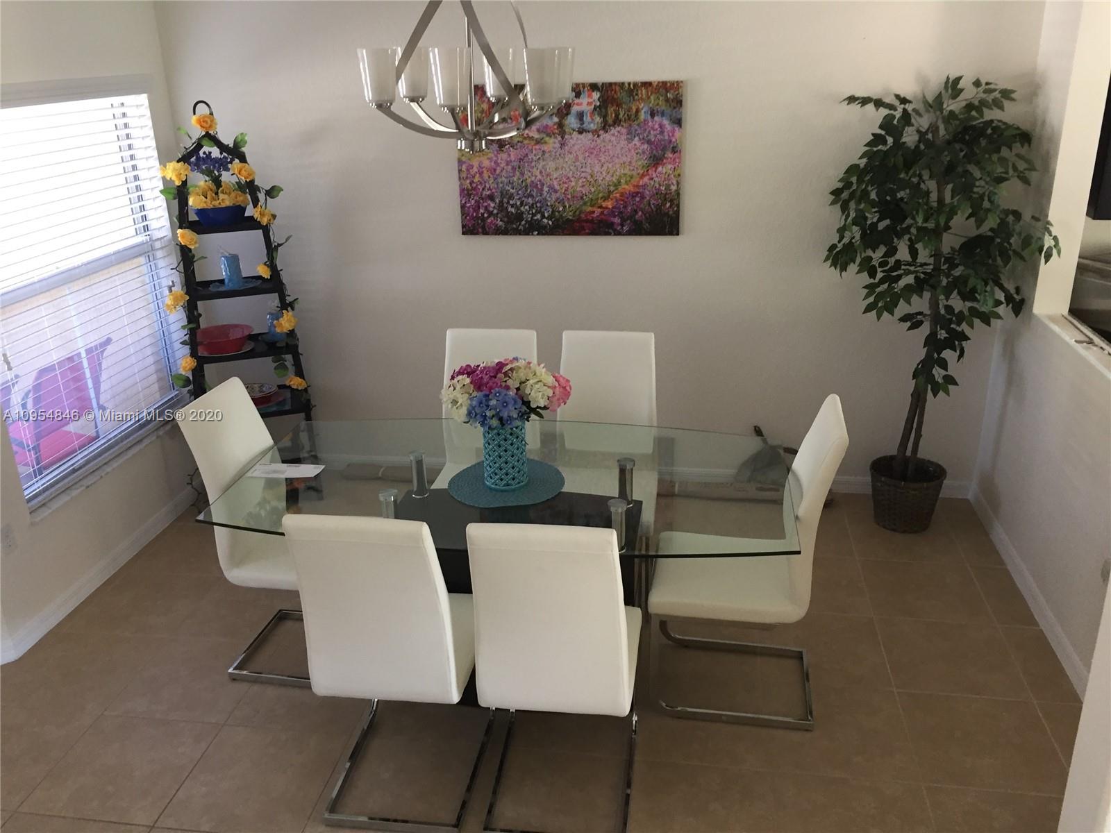 2851 Prospect Road, Unit 1306 Tamarac, FL 33309 - Photo 5 of 15 a living room with furniture and flowers