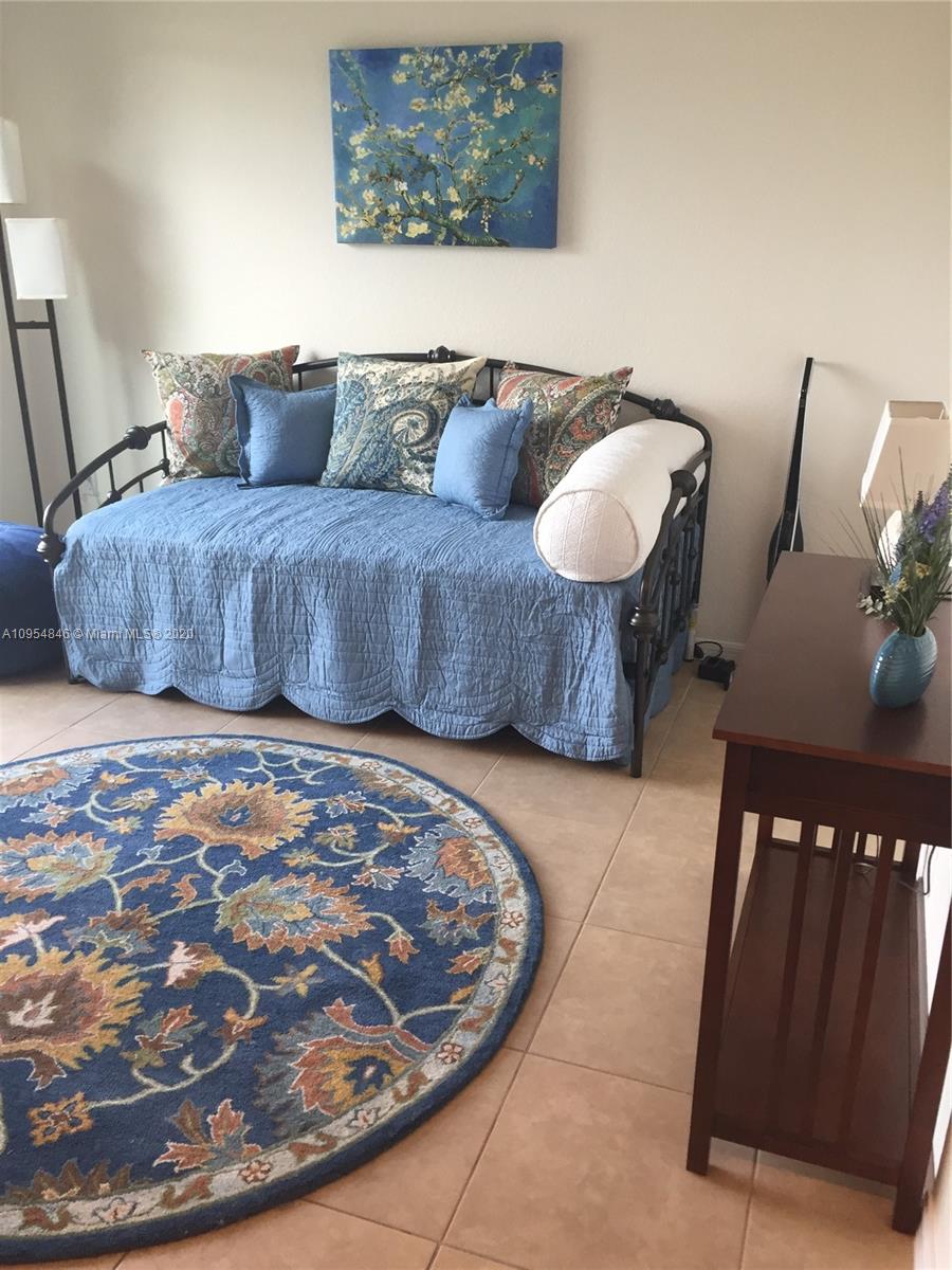 2851 Prospect Road, Unit 1306 Tamarac, FL 33309 - Photo 8 of 15 a living room with furniture and a rug