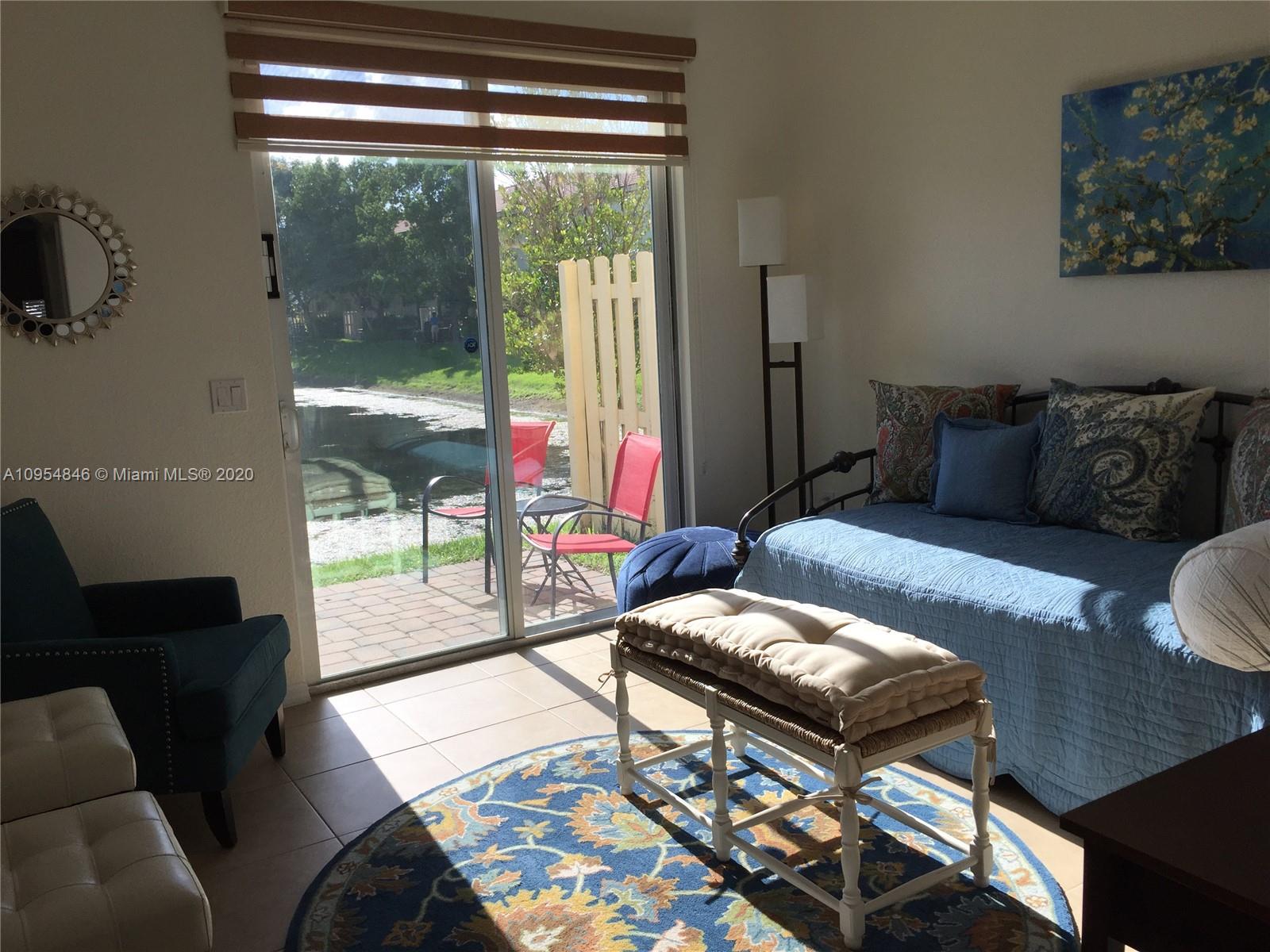 2851 Prospect Road, Unit 1306 Tamarac, FL 33309 - Photo 9 of 15 a living room with furniture and a floor to ceiling window