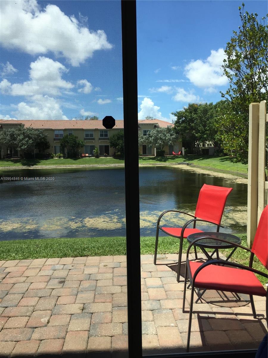 2851 Prospect Road, Unit 1306 Tamarac, FL 33309 - Photo 10 of 15 a view of swimming pool with lawn chairs and large tree