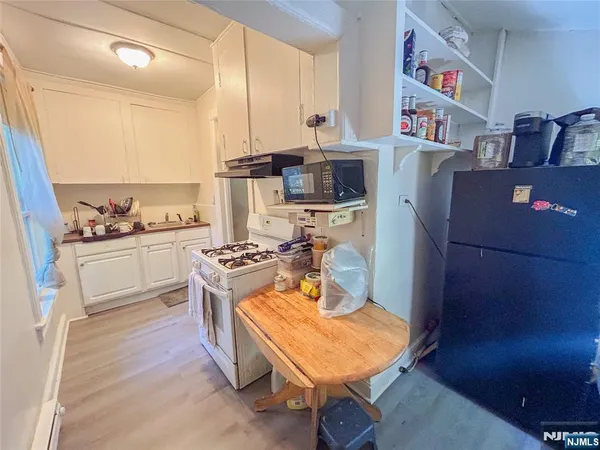 a kitchen with a stove and a refrigerator