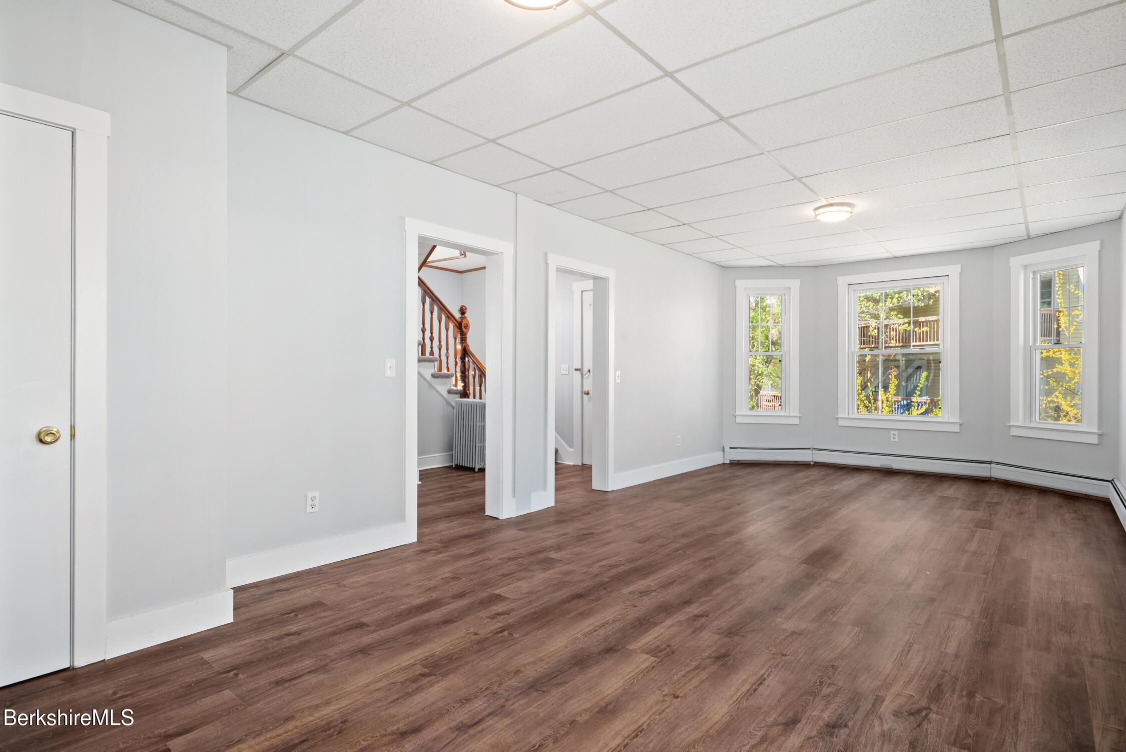 74 Washington Avenue North Adams, MA 01247 - Photo 12 of 31 an empty room with wooden floor and windows