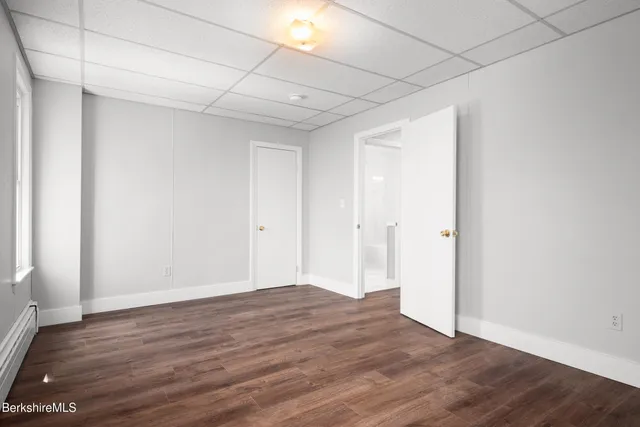 a view of an empty room with wooden floor