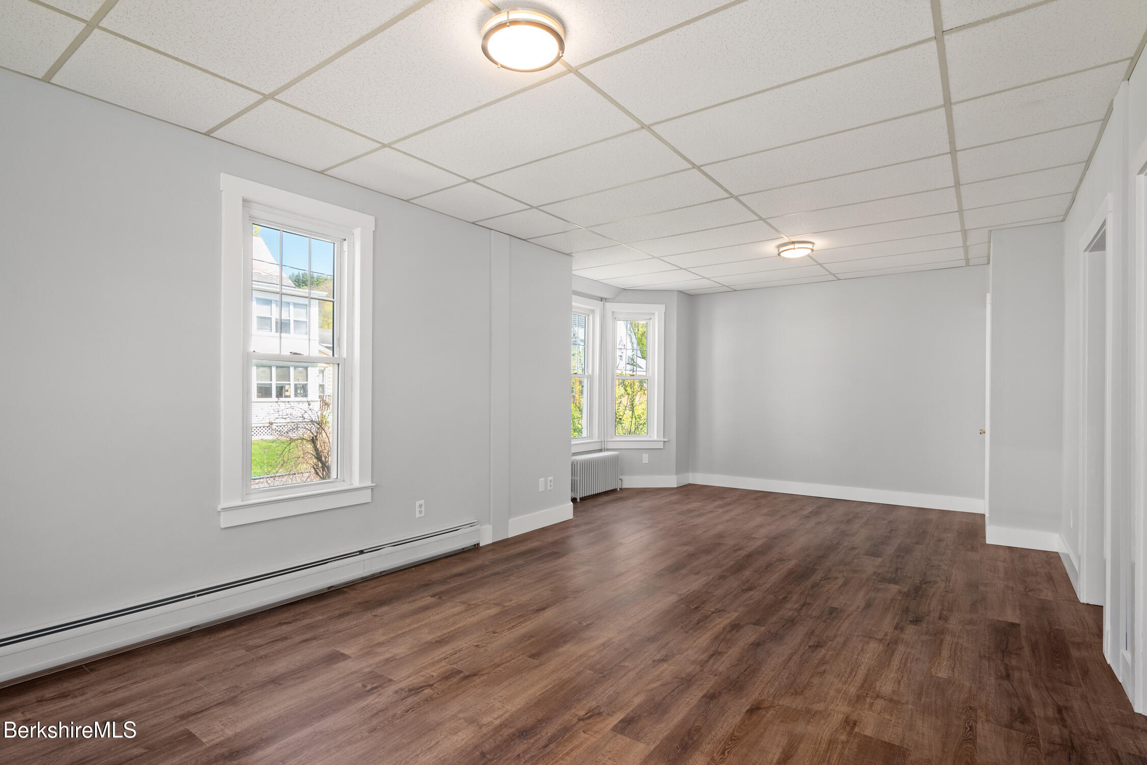74 Washington Avenue North Adams, MA 01247 - Photo 10 of 31 an empty room with wooden floor and windows