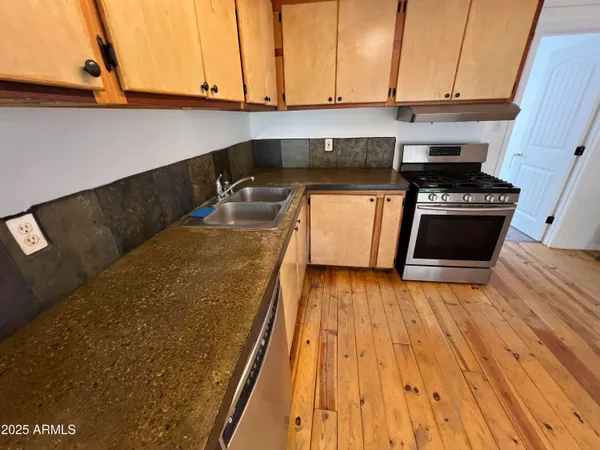 a kitchen with wooden floors and a stove