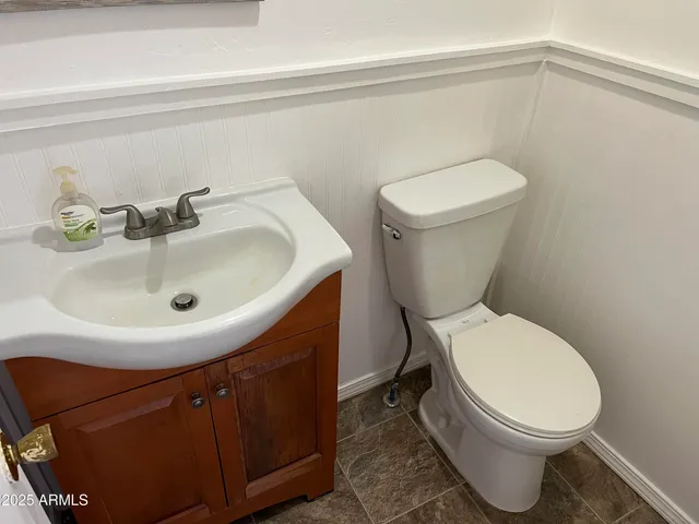 a white toilet sitting next to a bathroom sink