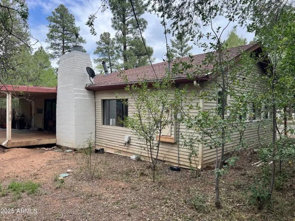 a brick house with a tree in front of it
