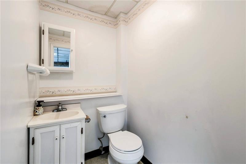 3030 Wilmington Road New Castle, PA 16105 - Photo 14 of 41 a bathroom with a toilet a sink and mirror