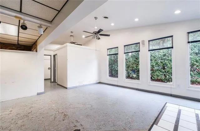 a view of a livingroom with a ceiling fan and window