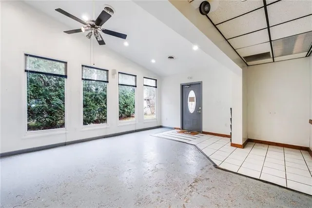 a view of a livingroom with a ceiling fan and window