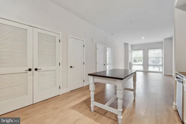 a view of a livingroom with wooden floor and furniture