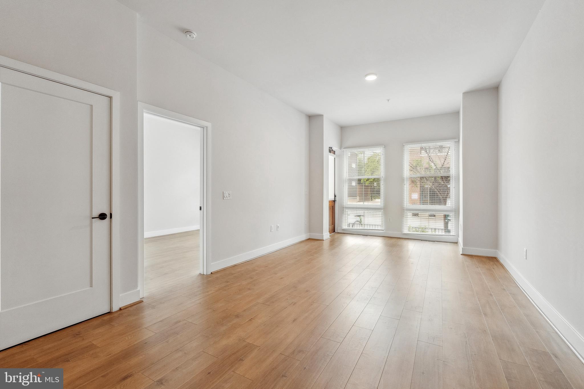 1339 E Street Southeast, Unit 230 Washington, DC 20003 - Photo 15 of 35 a view of an empty room with wooden floor and a window