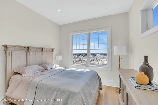 a bedroom with a large bed and a window