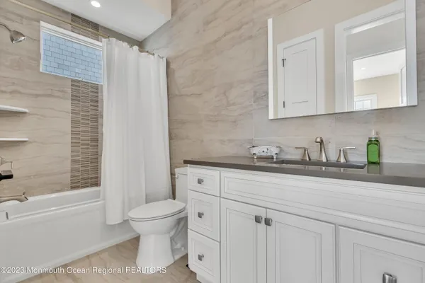 a bathroom with a sink a toilet and a bathtub