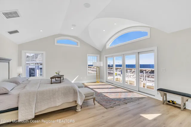 a bedroom with a bed and a large window with the outer view