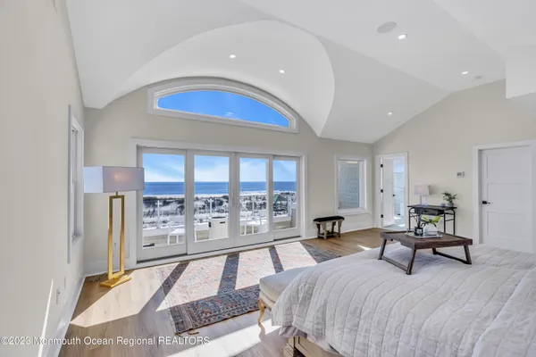 a bedroom with a large bed and a large window
