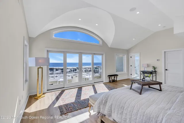 a bedroom with a large bed and a large window