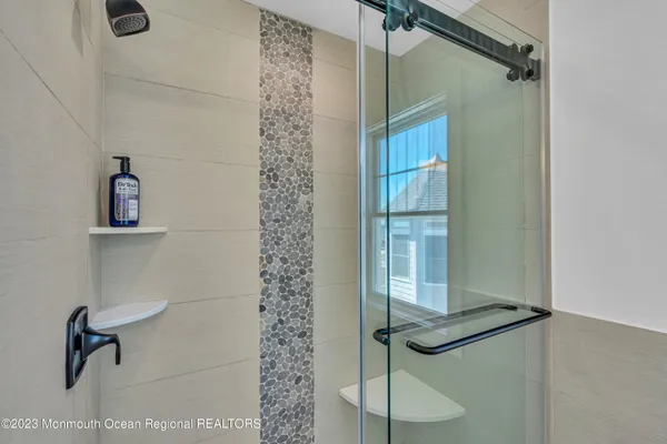a bathroom with a sink and two mirror